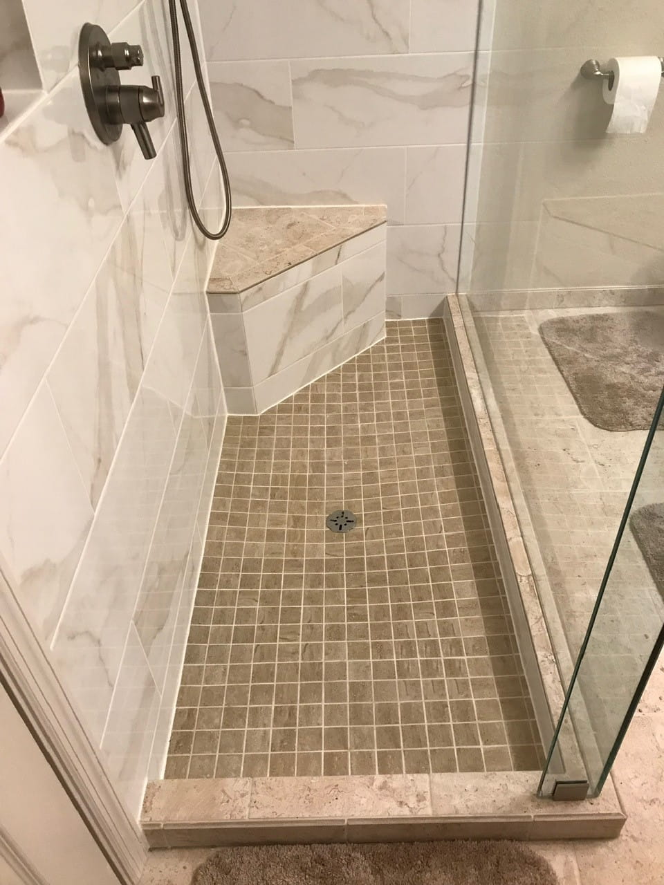 Grey linear mosaic tile shower wall with square showerhead