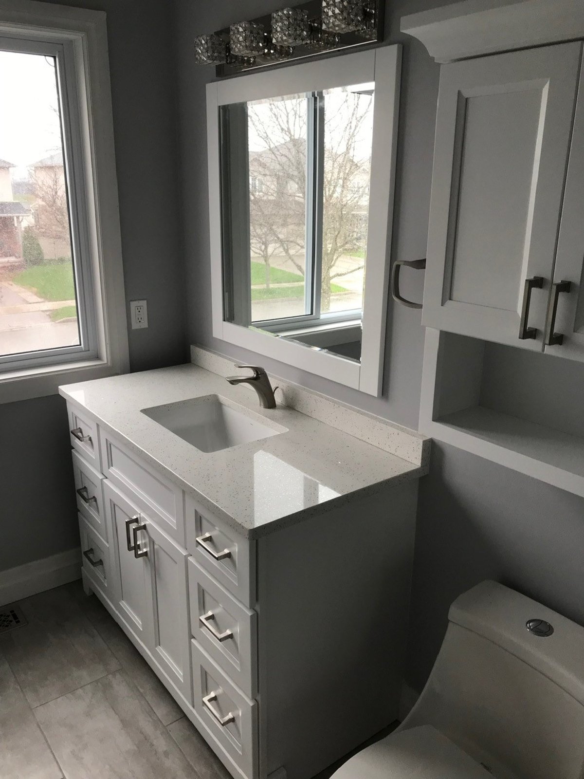 Wall-mounted bathroom mirror above a vanity