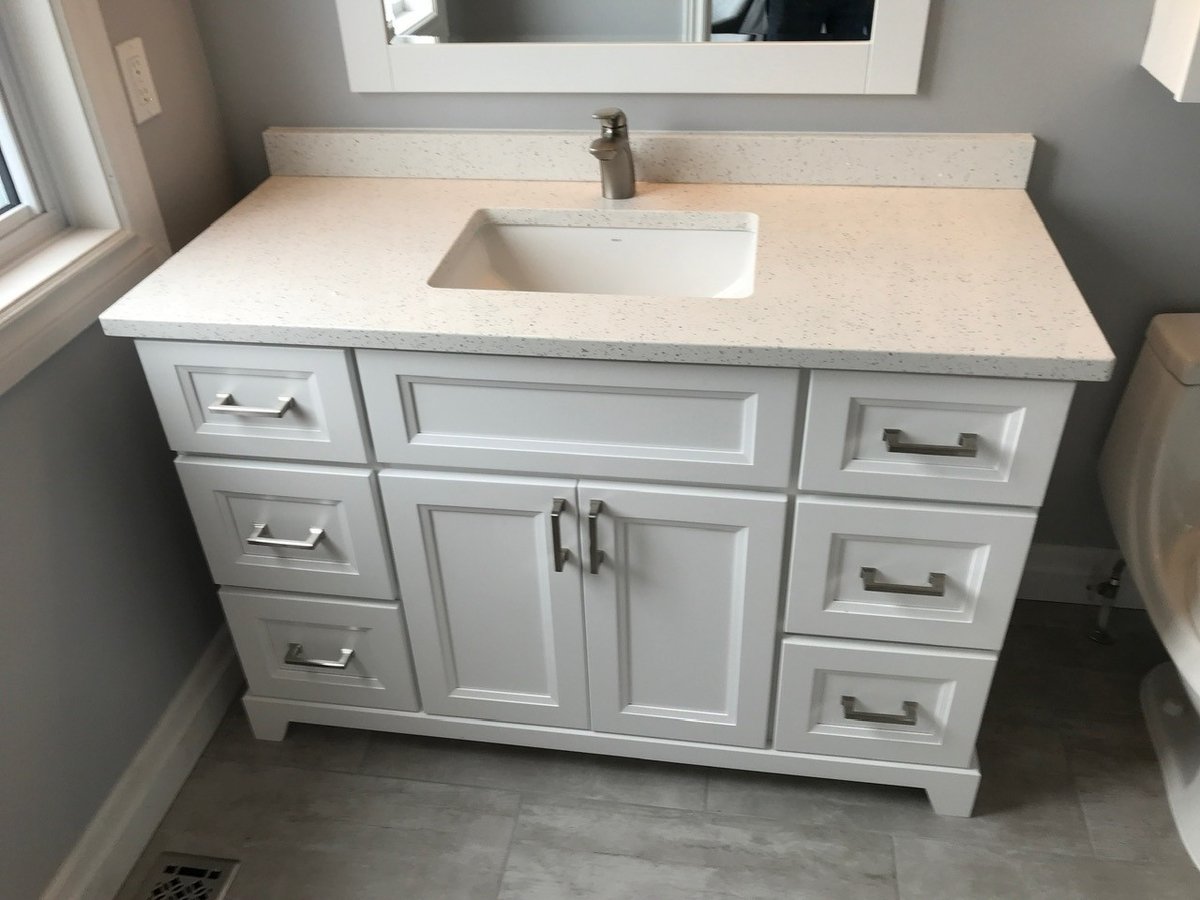 Installed bathroom vanity with countertop and sink
